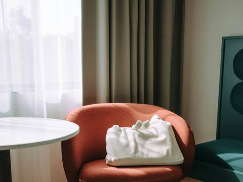 A coral armchair by the window