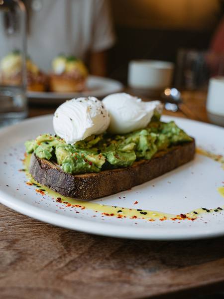 Avocado and poached eggs on toasted sourdough