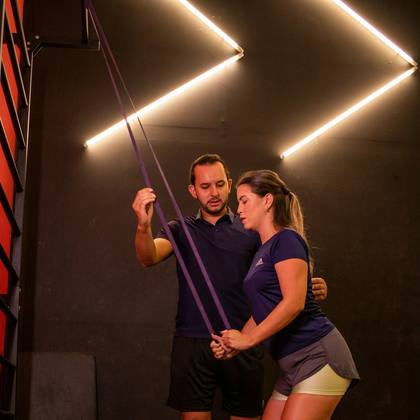 A physiotherapist coaching a resistance band exercise