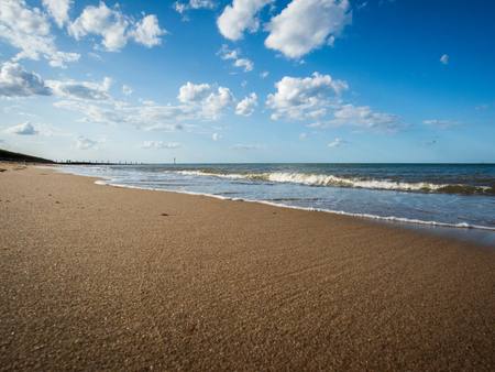 The sandy beach below the cliffs on a sunny day