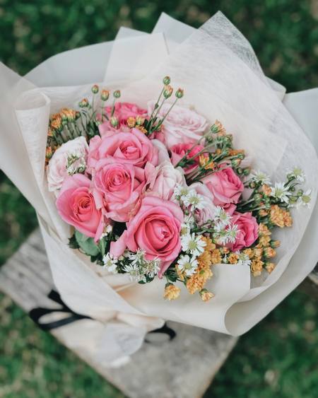 Pink roses wrapped in white tissue