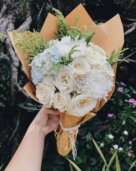 Ivory roses held in kraft paper