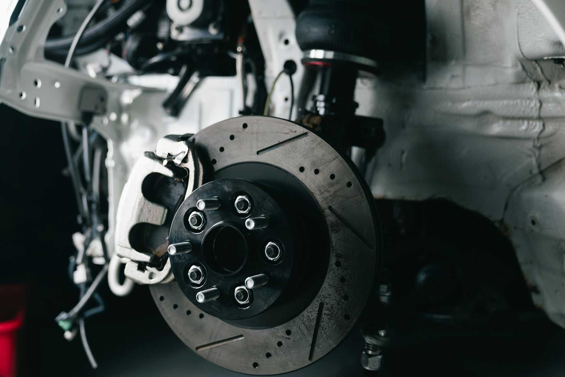 A performance brake disc and caliper behind an alloy wheel