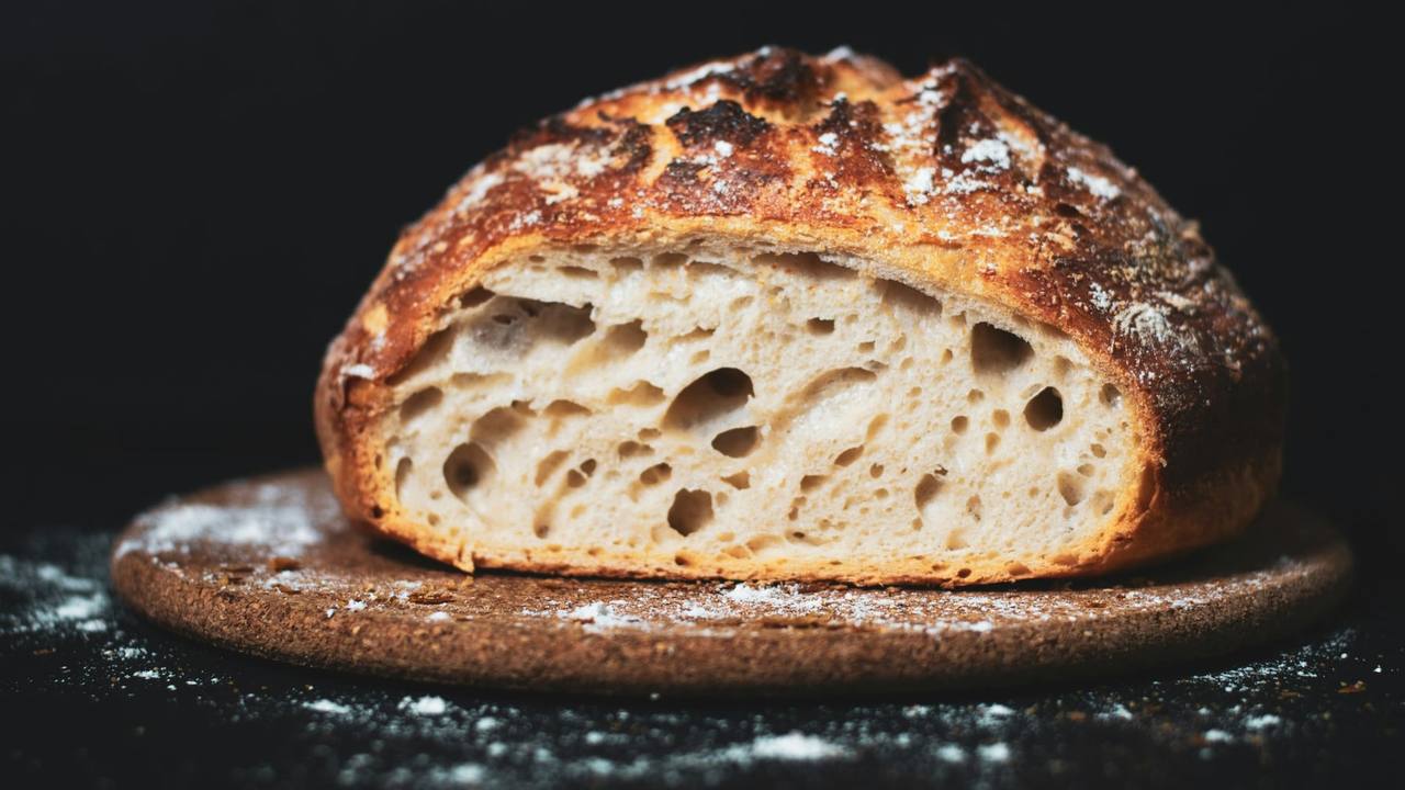 A sourdough loaf, cut open on a board