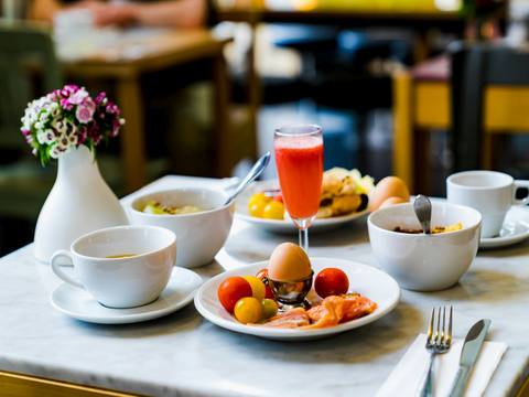 Breakfast laid out with juice, eggs and pastries