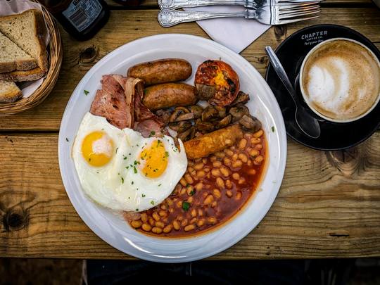 A full English breakfast with eggs, bacon, beans and a coffee