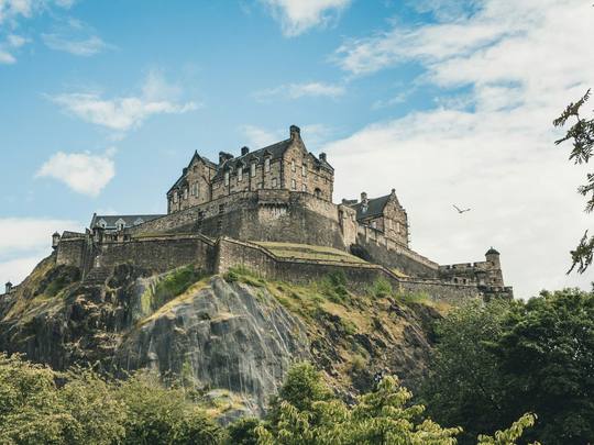 Edinburgh Castle on its rock under a blue sky