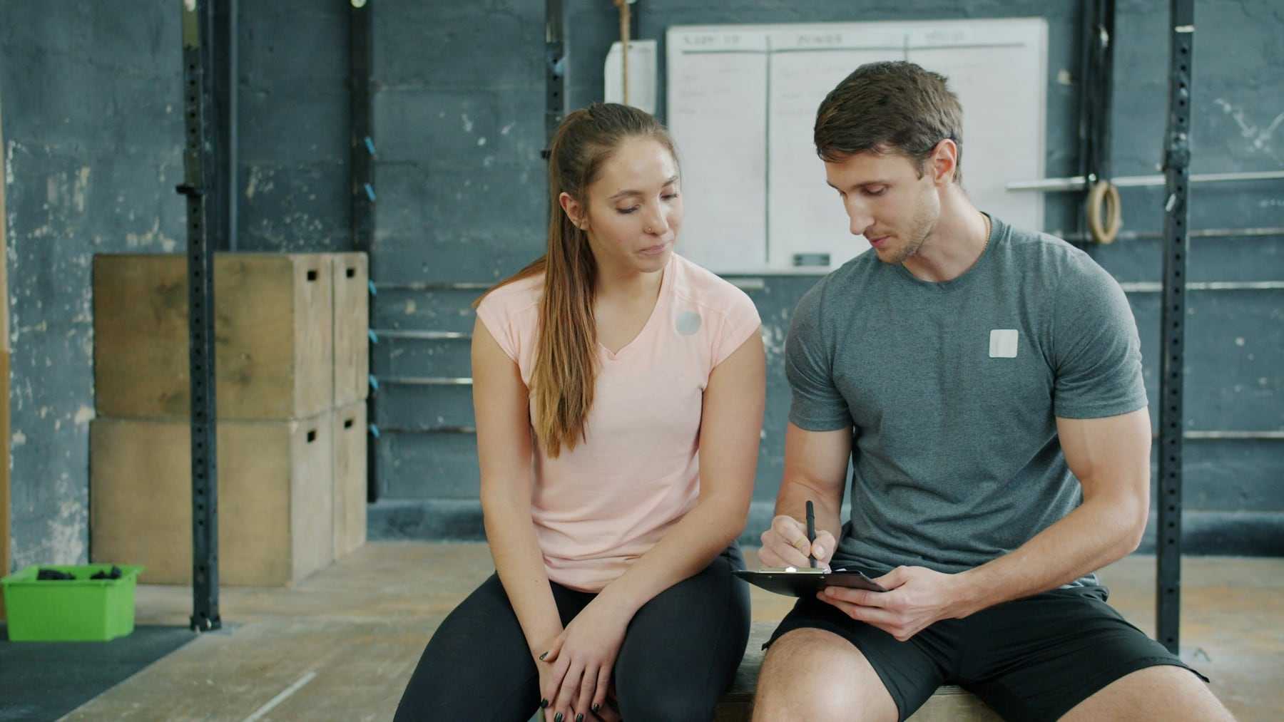 A coach and a member talking through a training plan