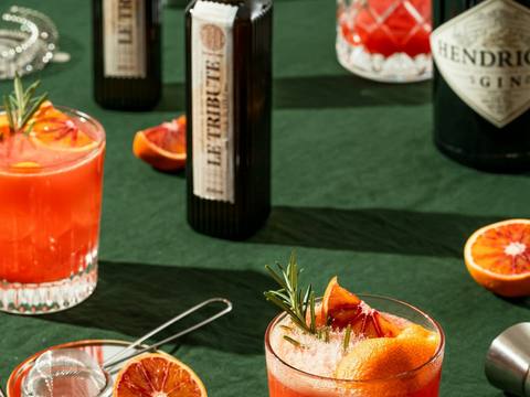 Blood orange cocktails on a green linen tablecloth