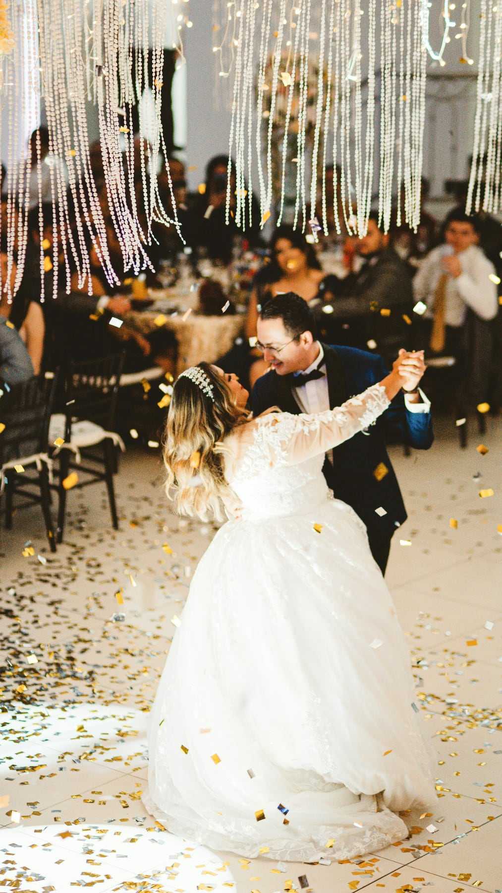A bride dancing as confetti falls around her