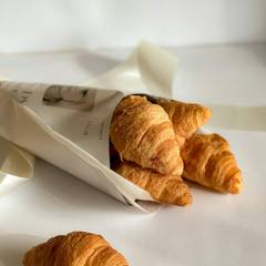 Butter croissants in a paper bag