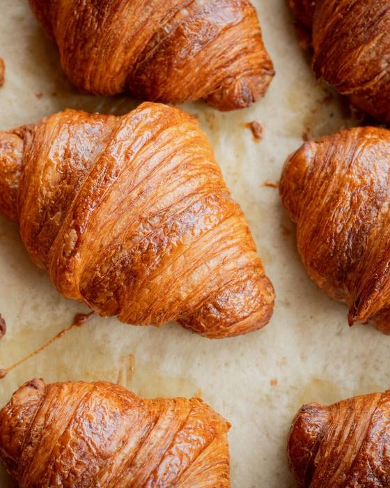 A tray of golden butter croissants fresh from the oven