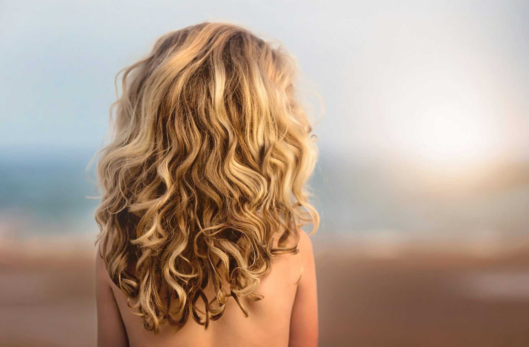 Golden blonde curls from behind