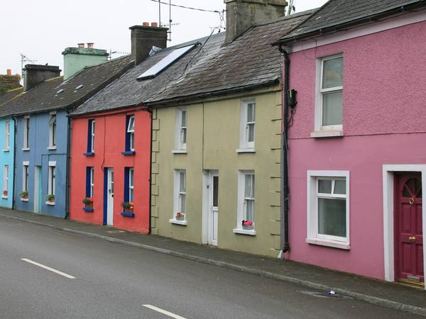 A row of brightly painted terraced houses on a hill