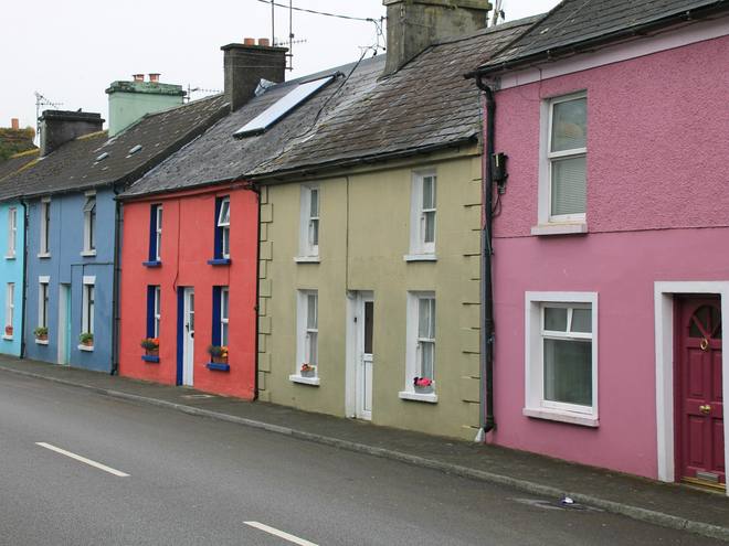 A row of brightly painted terraced houses on a hill