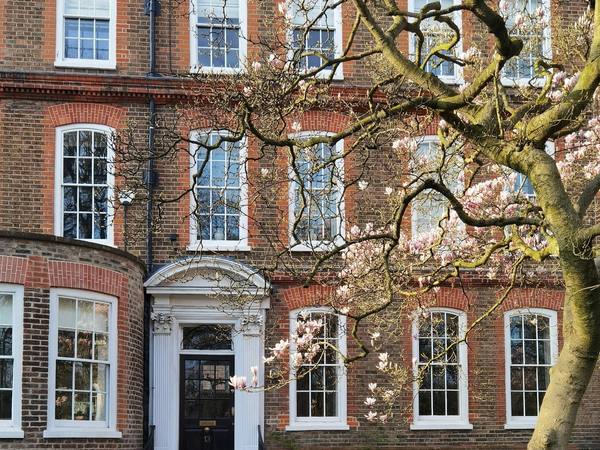 A red brick Georgian house with stone steps up to the door