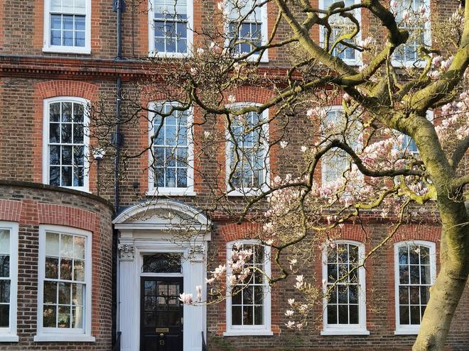 A red brick Georgian house with stone steps up to the door