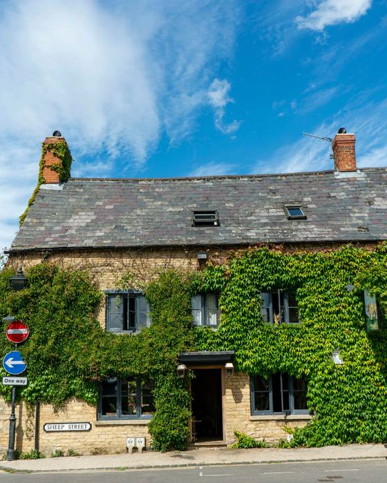 The inn, an old stone building covered in green ivy