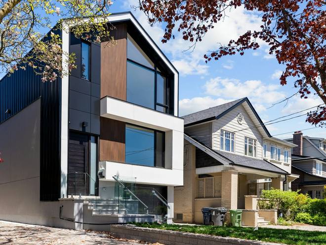 A contemporary house with black and timber cladding