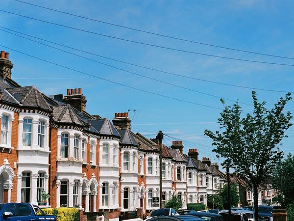 A long street of red brick Victorian terraced houses