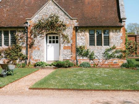 The flint cottage seen from the garden path