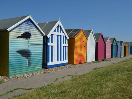 A row of colourful beach huts on the promenade