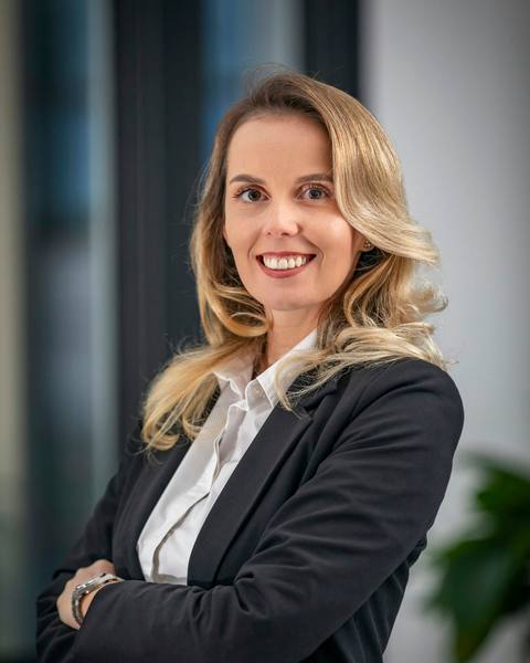Catherine Ashworth, senior partner, standing with arms folded