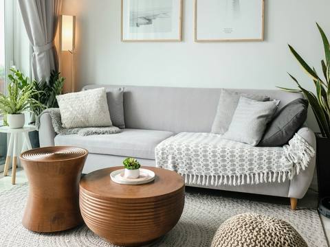 A calm living room with a white sofa and round coffee tables