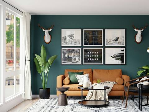 A living room with a teal feature wall and a tan sofa