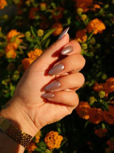 Oval nails in a warm mocha nude against autumn flowers