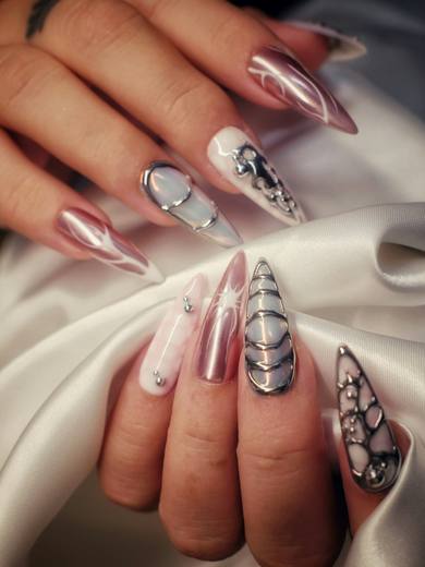 Long stiletto nails with metallic and jewelled designs