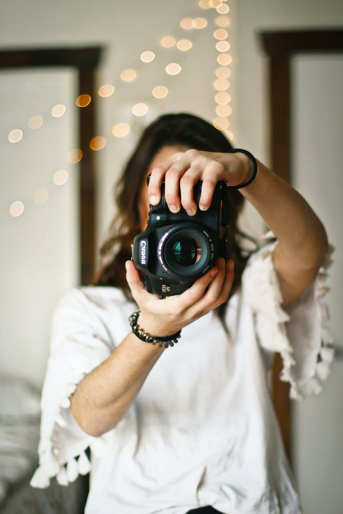 Isla holding a camera up to her face, smiling