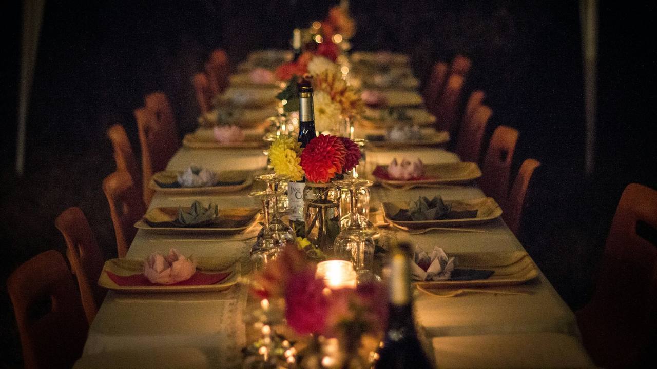 A long table set with flowers and candles for a party