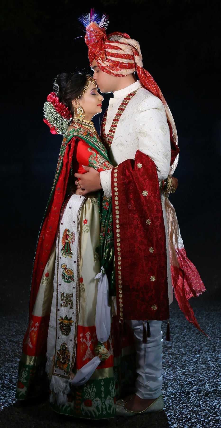 A couple in traditional red wedding clothes