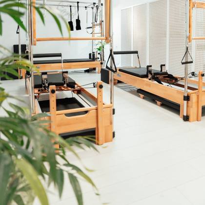 The Pilates studio with reformer machines and plants