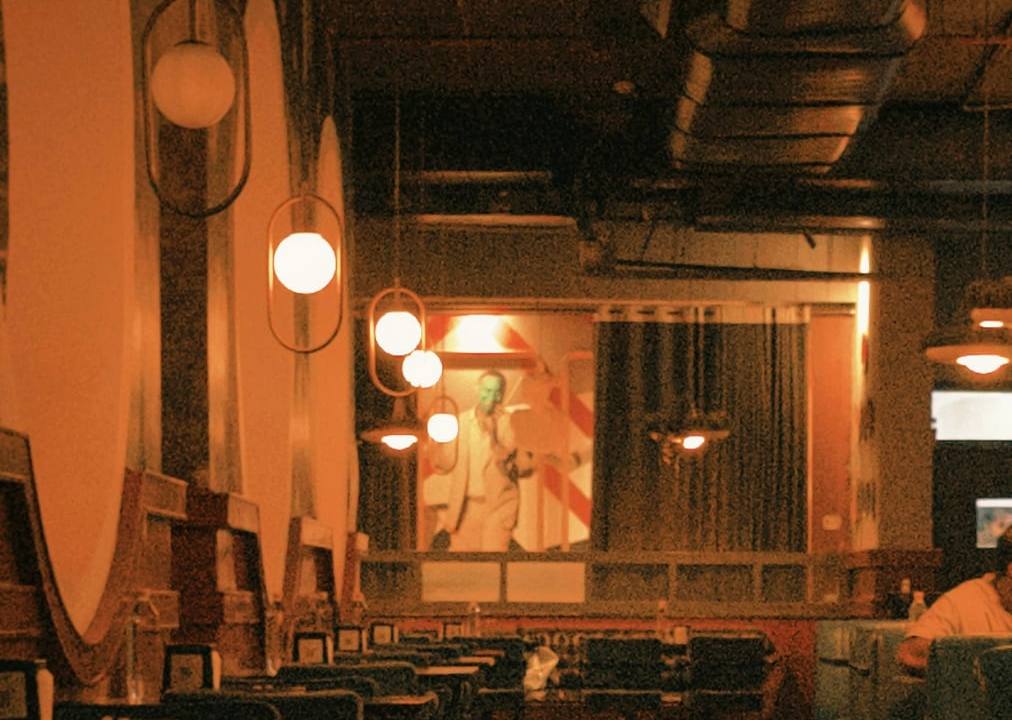 The dining room at night under warm pendant lights