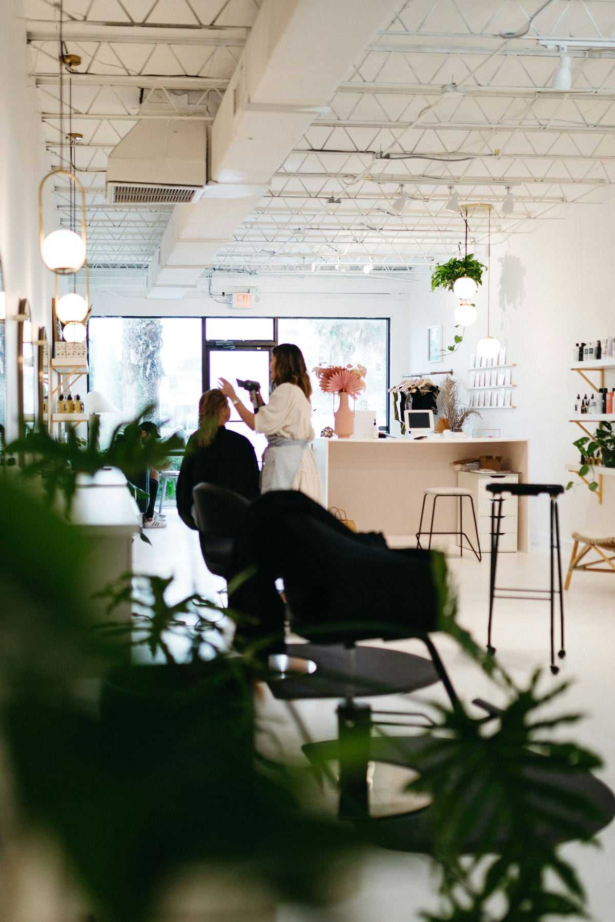 The salon floor with plants, mirrors and natural light