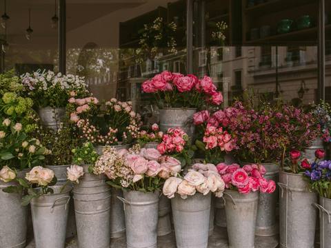 Zinc buckets full of roses, stocks and lisianthus