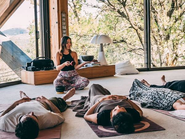 People lying under blankets during a sound bath