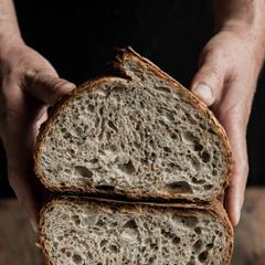 A seeded rye loaf cut in half