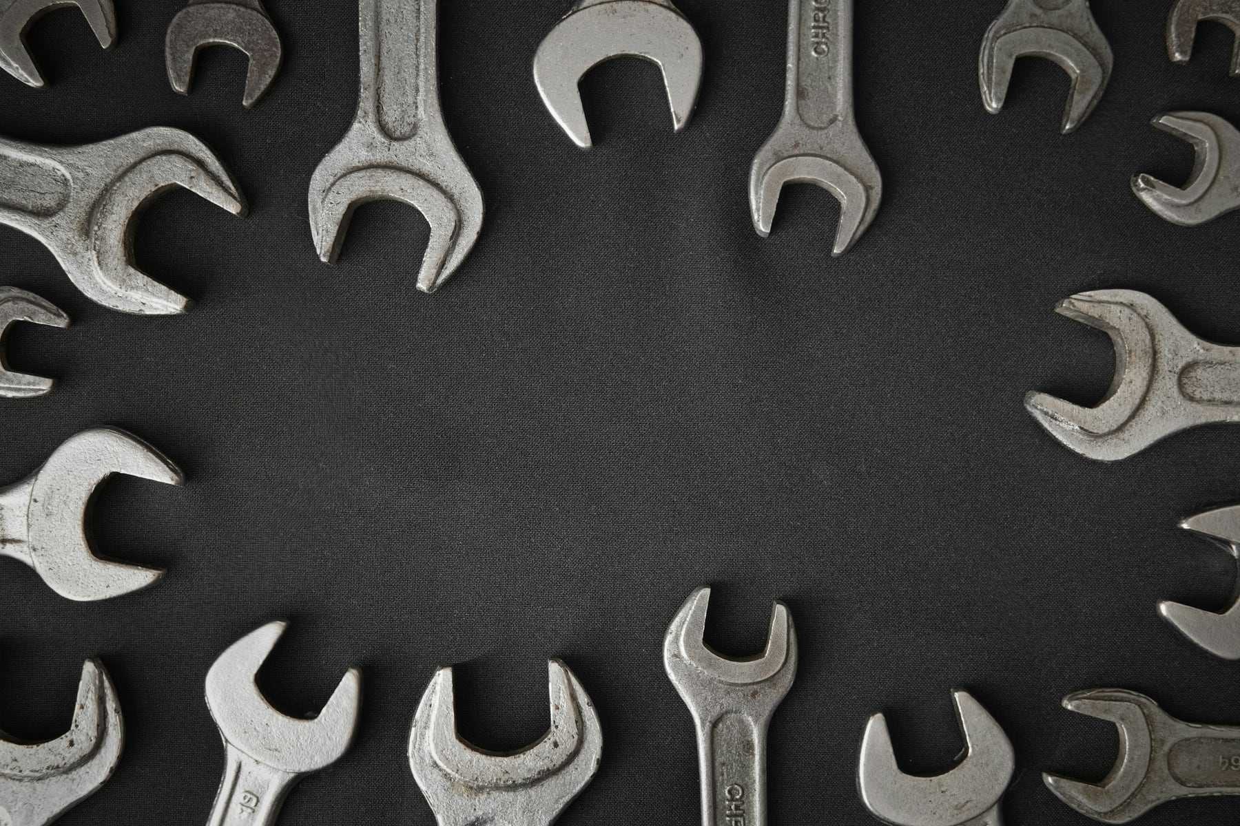 A ring of spanners laid out on a dark surface
