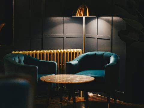 A quiet corner of the bar with a velvet chair
