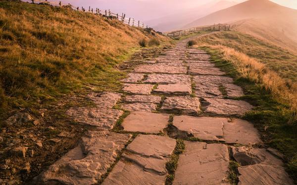 A flagstone path climbing a hill at dusk